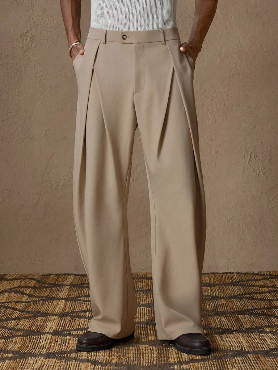Model wearing men's Italian pleated dress trousers in khaki with a high-waisted fit