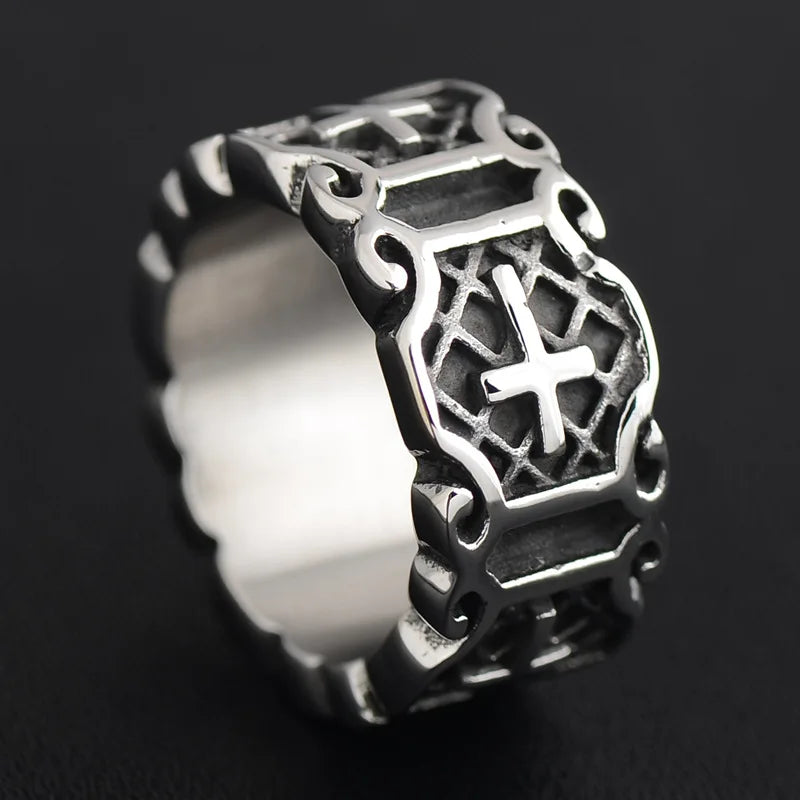 Thick men's silver ring displaying a carved Templar cross motif standing upright against a black background.