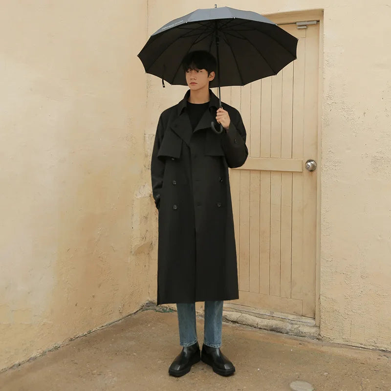 Full view of men's extended length winter trench coat with waist belt accessory