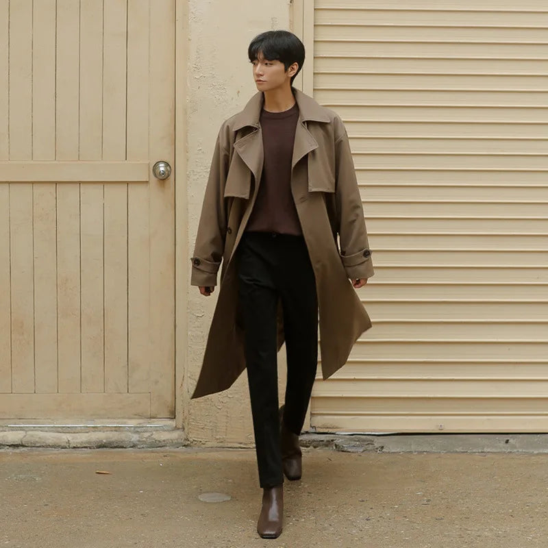 Full body view of man wearing loose mid length casual overcoat jacket in khaki brown