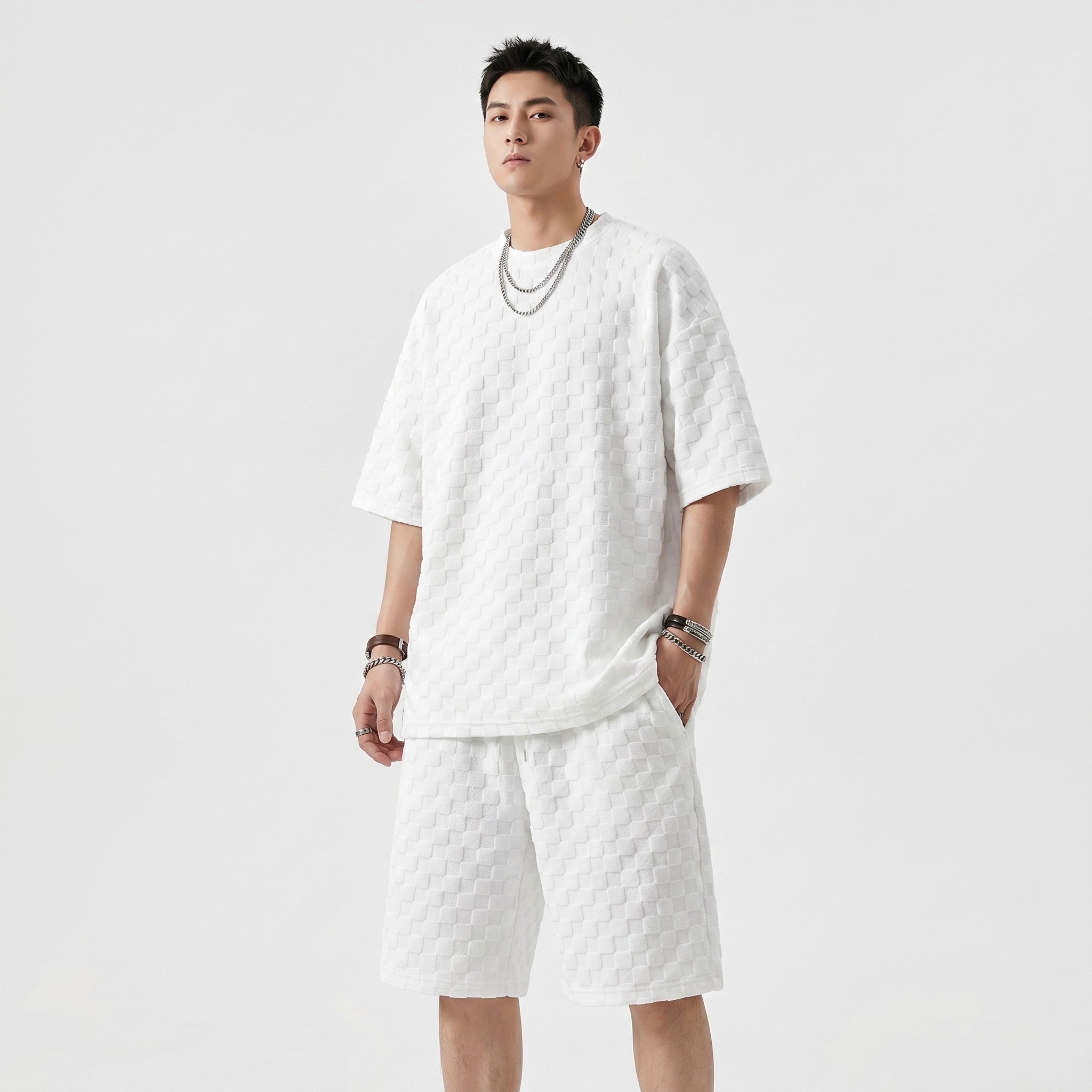 Front view of a male model showcasing the preppy style relaxed silhouette of the solid white jacquard knit two-piece outfit