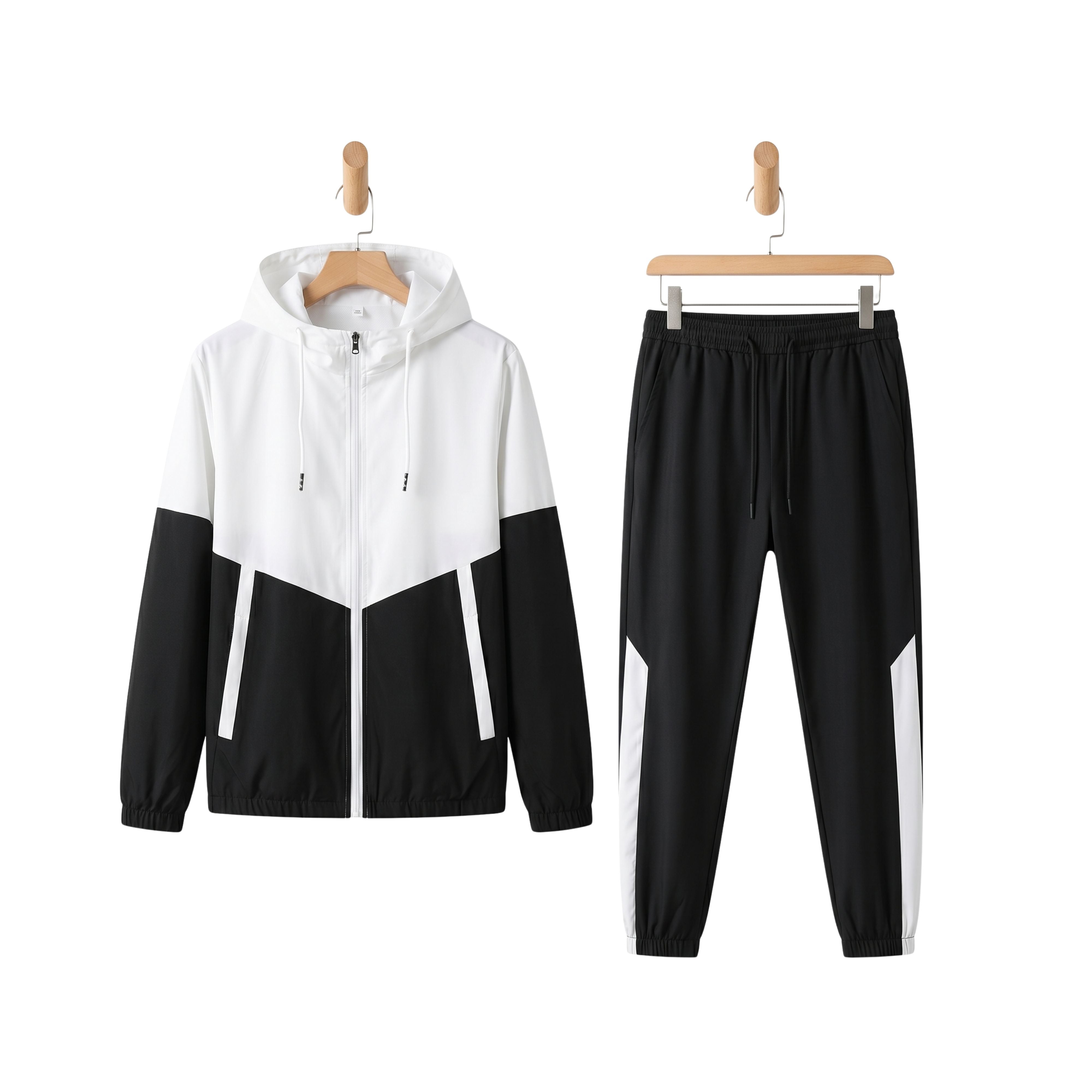 Men's Metropolitan Vibe two-piece sportswear tracksuit featuring a white and black geometric patchwork hooded zip jacket and matching joggers on hangers