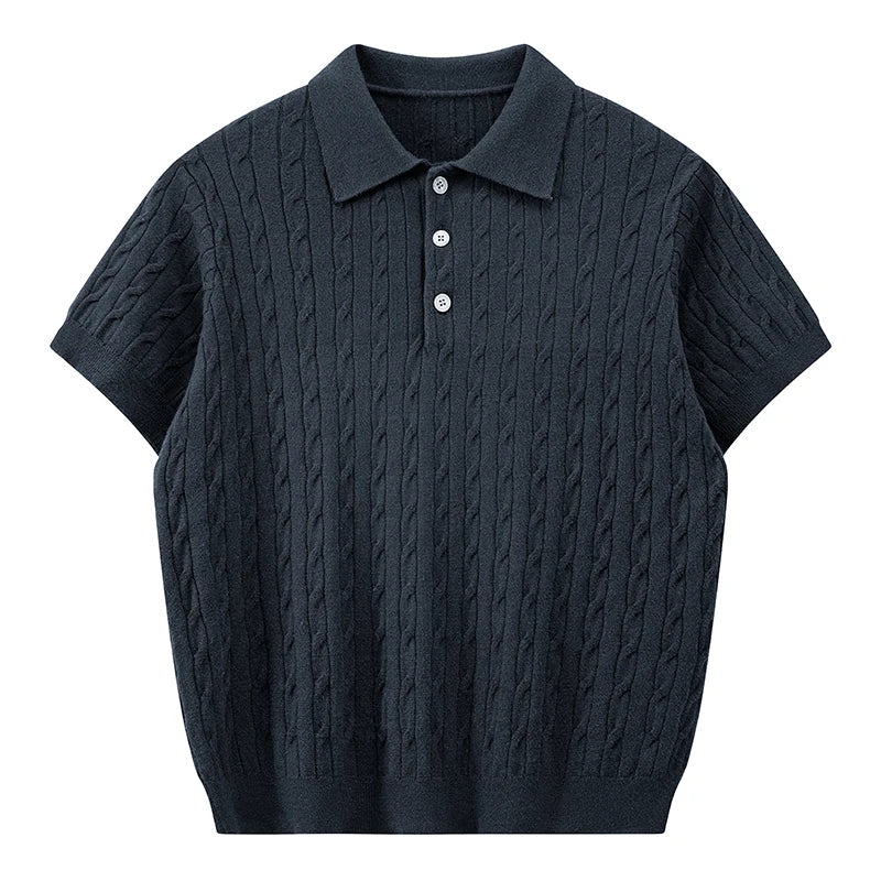 Front view of a deep navy blue men's short-sleeve cable knit polo shirt with dark buttons against a white background