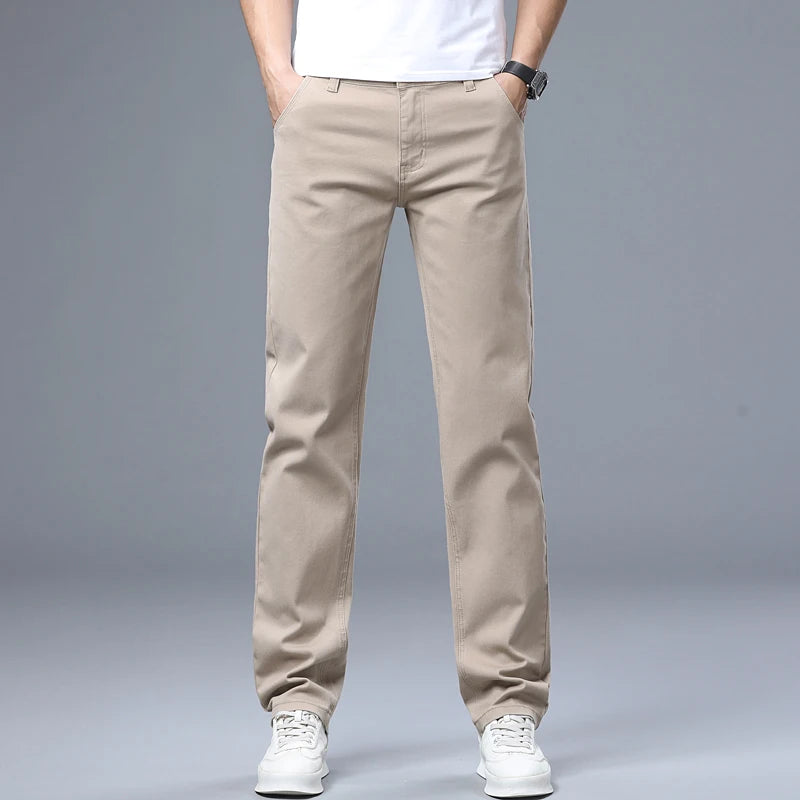 Front catalog model view showcasing the sand beige mid-rise slim straight daily trousers styled with white casual tennis shoes