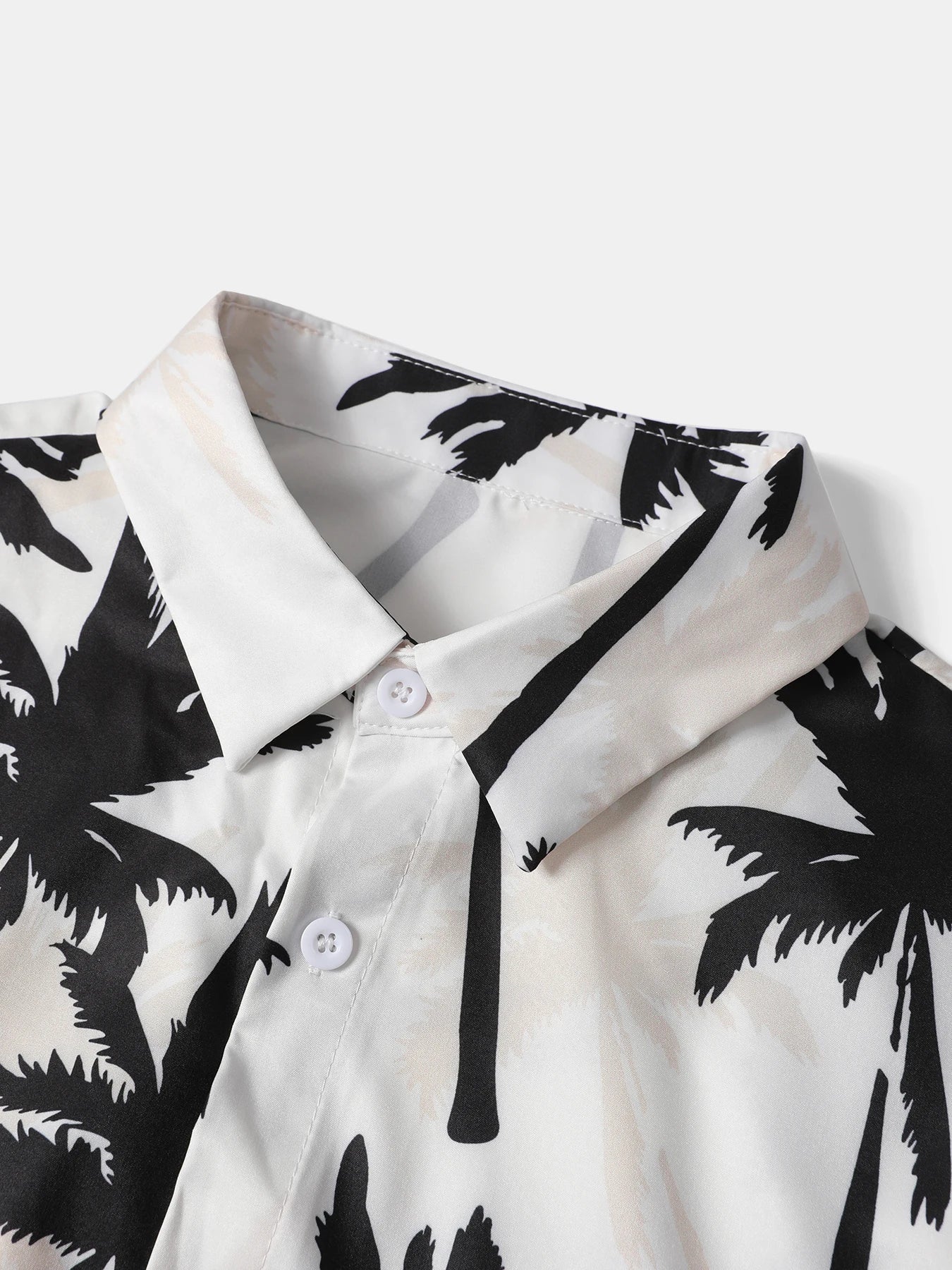 E-commerce product display showcasing the yellow-accented tropical palm tree short-sleeve shirt and mustard yellow shorts on a textured wall