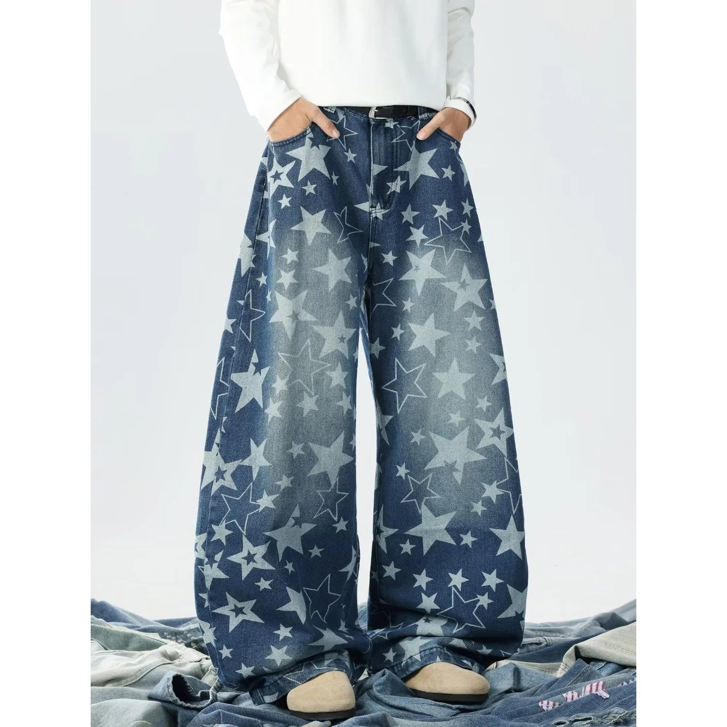 Front view of a model showcasing baggy blue jeans with a bold all-over light blue star pattern print