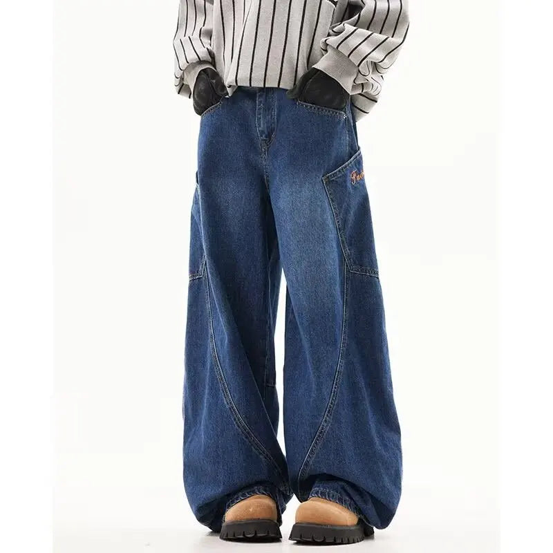 Model wearing blue high-street wide-leg denim trousers with curved vertical stitching panel details