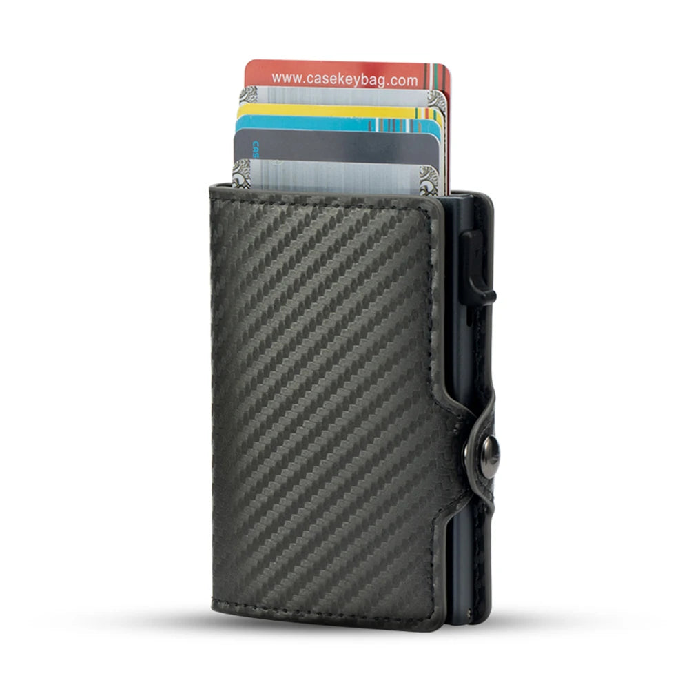 Studio product shot of the charcoal grey carbon fiber CaseKey mini wallet with a mechanically extended fanned-out stack of multiple credit cards