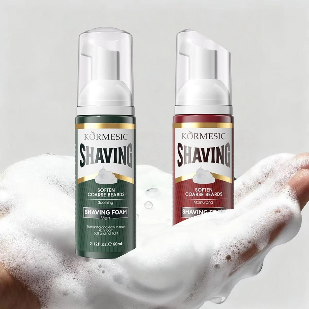 A hand holding both Kormesic shaving foam bottles over a thick layer of dense white micro-bubbles