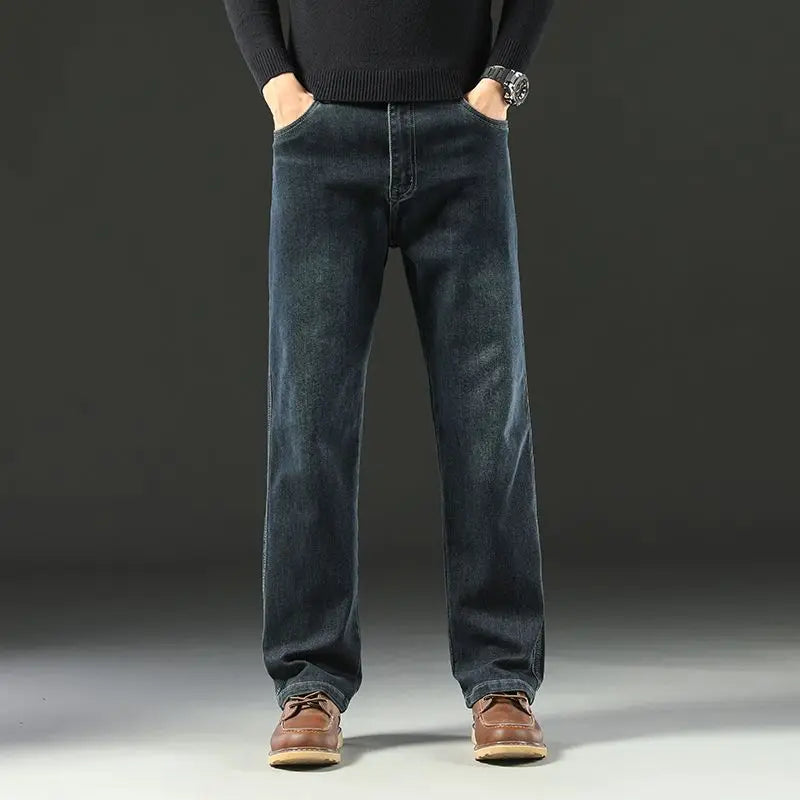 Front standing view of a male model presenting the dark wash loose straight denim pants, highlighting the flexible midweight fit