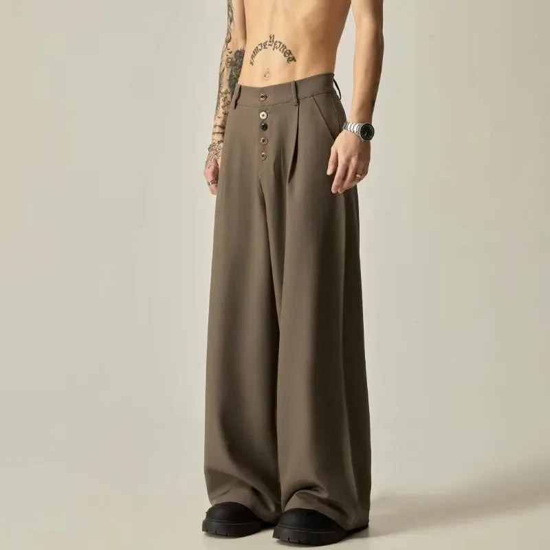 Model wearing men's olive brown baggy trousers showing the unique multi-colored button fly detail