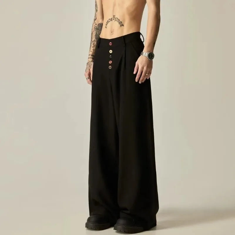 Front view of a model showcasing the loose fit and high waistband drape of the black pleated trousers