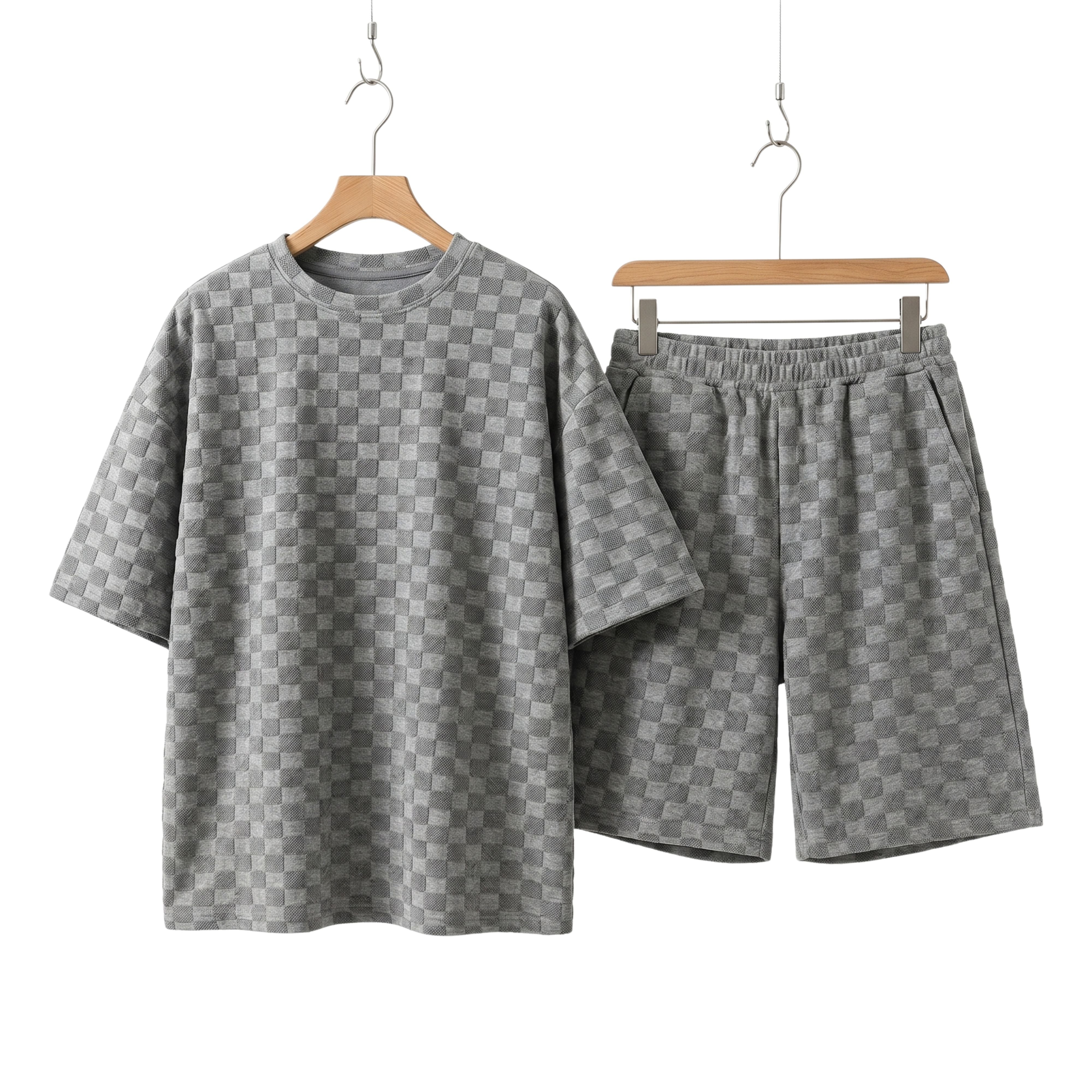 Men's Seoul Street two-piece coordinated set in grey jacquard plaid, showcasing an oversized short-sleeve T-shirt and matching drawstring shorts on hangers