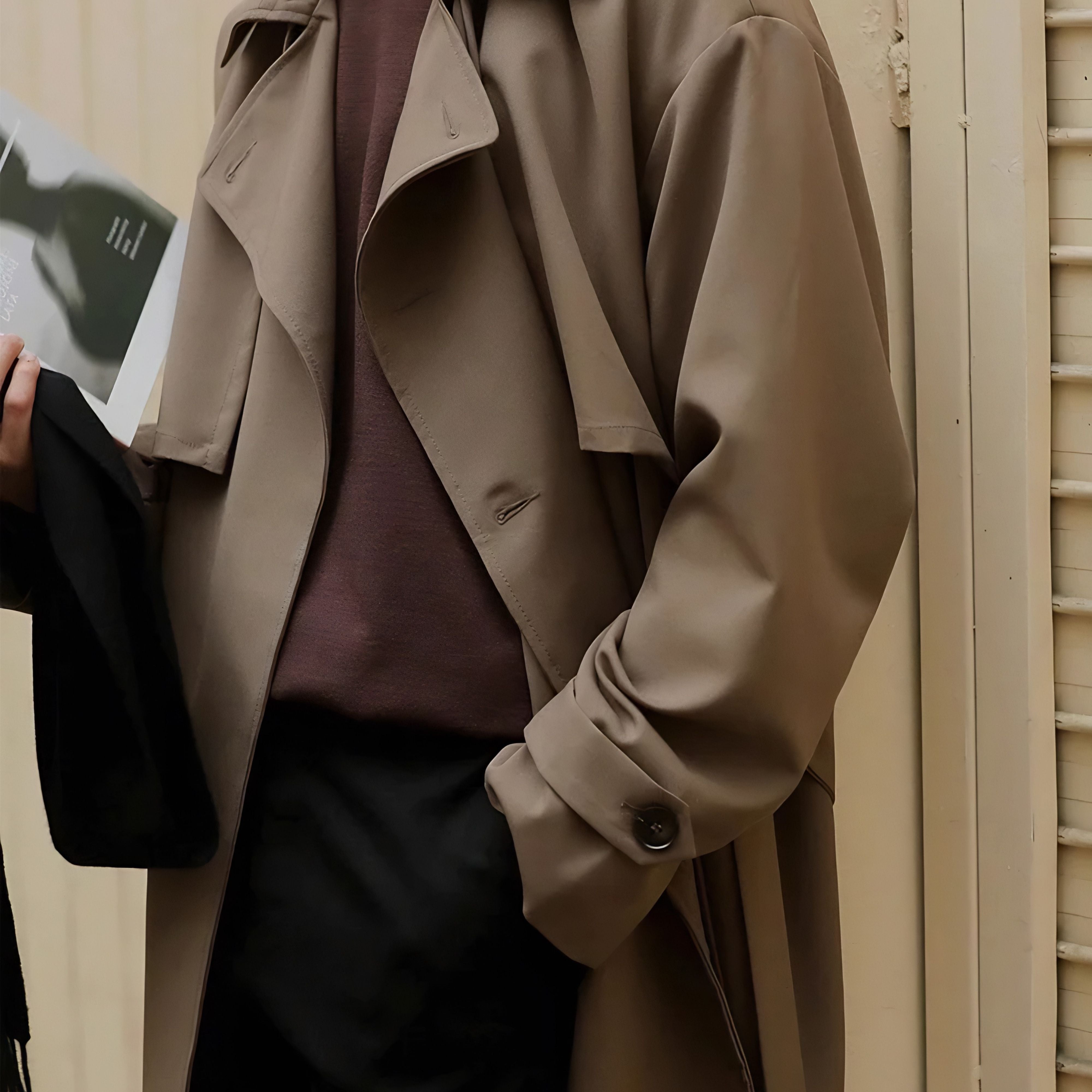 Chest view of man wearing loose mid length casual overcoat jacket in khaki brown