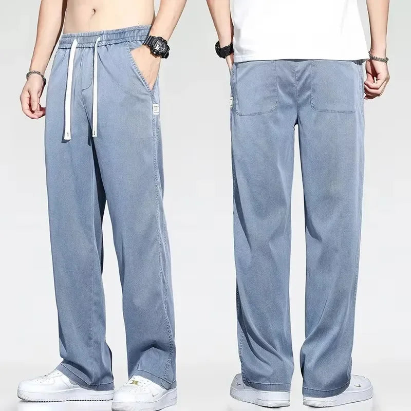 Front and back fit view of a man wearing relaxed fit light blue drawstring summer jeans with deep utility side pockets