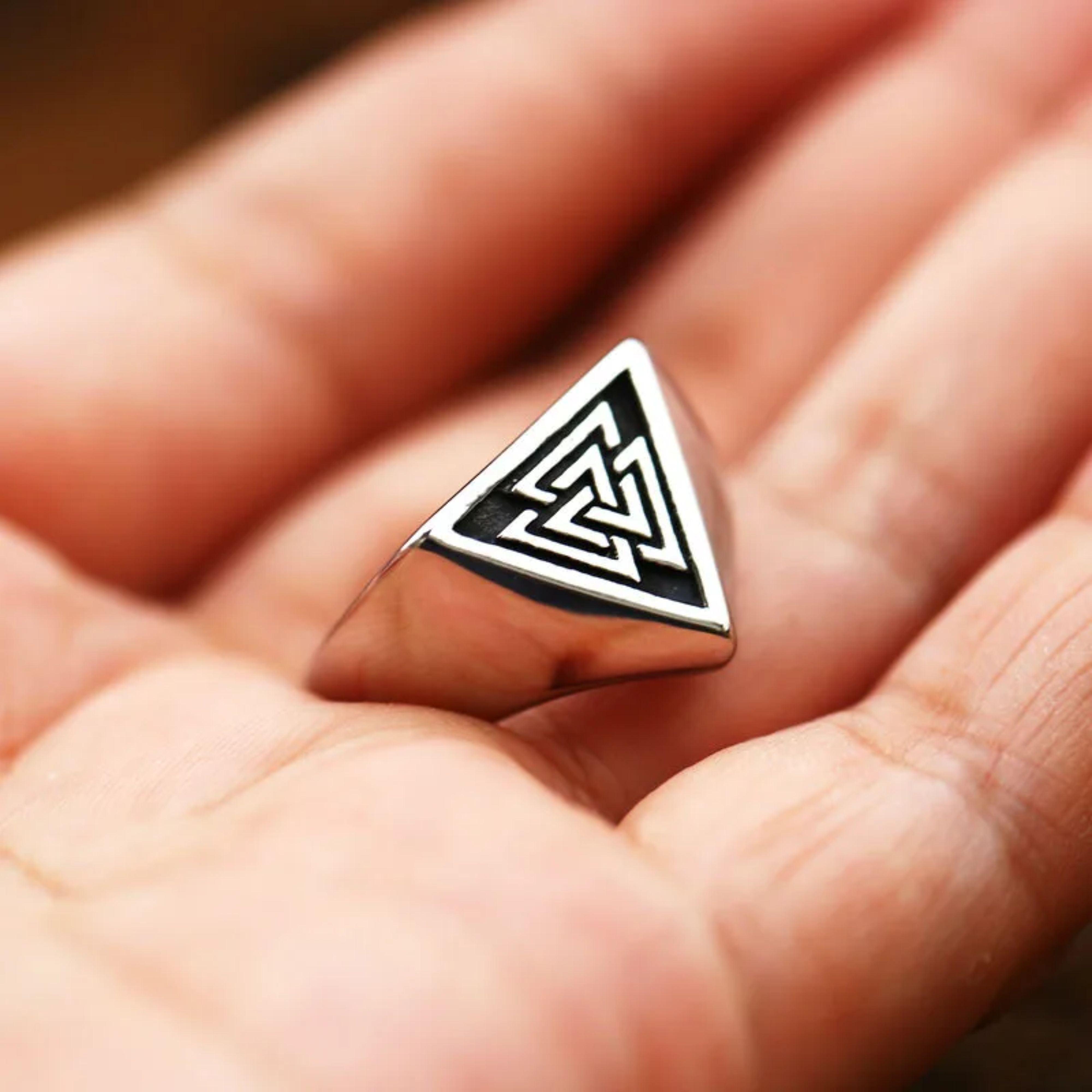 S925 sterling silver Valknut Viking ring being worn on a man's finger, showing its scale and fit.