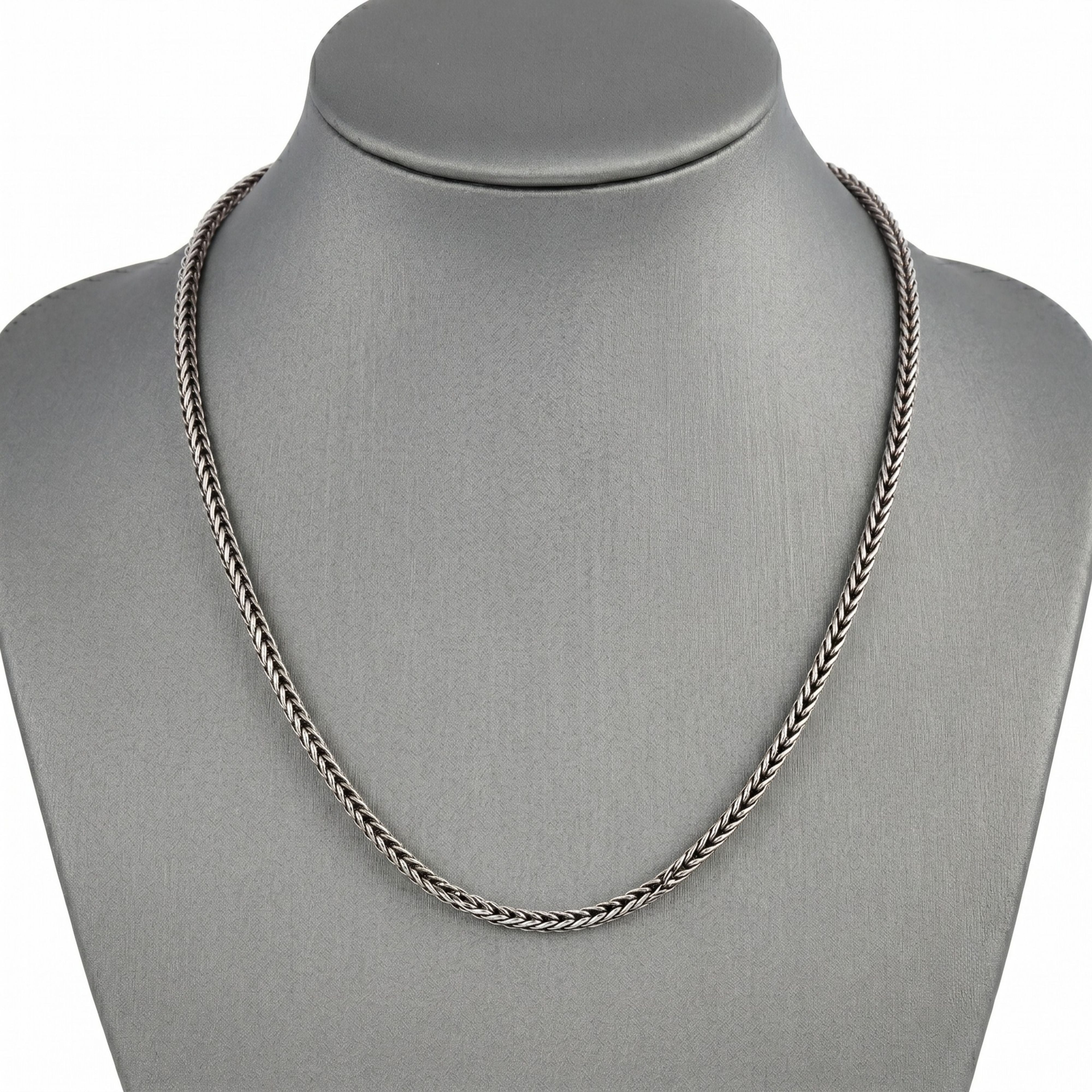 Men's vintage silver foxtail chain necklace displayed elegantly on a grey jewelry bust.