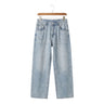 Men's Zen Breeze loose wide-leg straight jeans in distressed light wash blue denim hanging on a wooden hanger