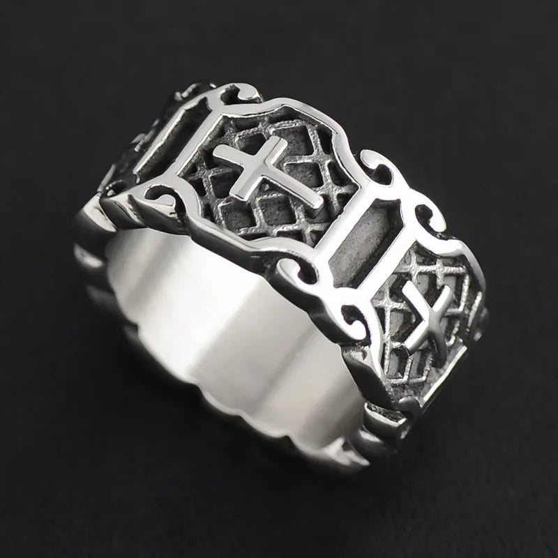 Side angle of a retro silver biker ring showing the continuous cross pattern and scalloped edges on a dark background.