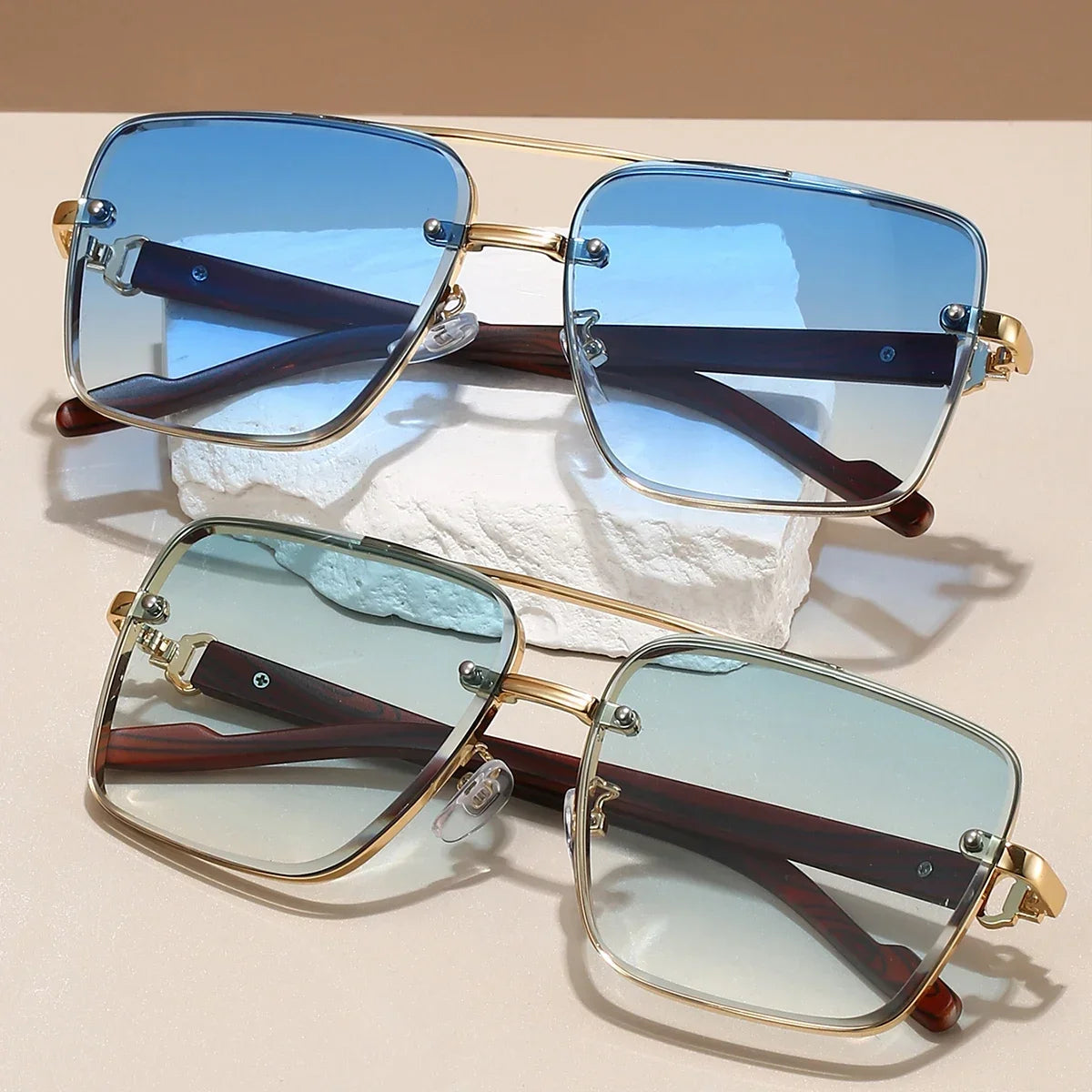 Two pairs of retro square metal sunglasses with wood temples featuring gradient blue and gradient teal lenses.