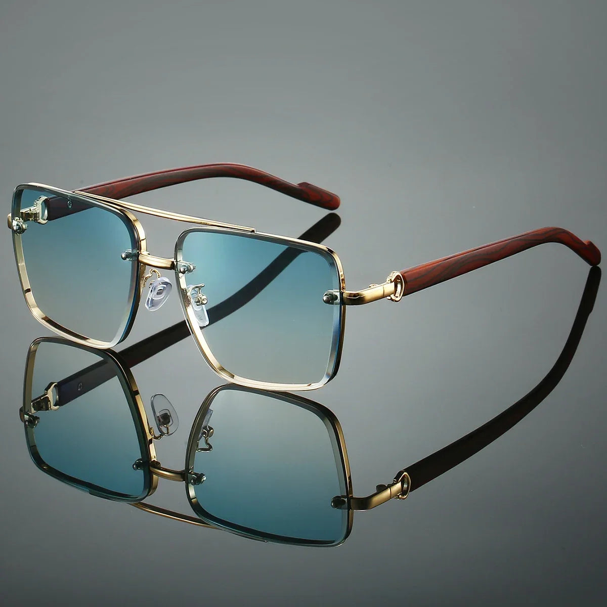 Retro square metal sunglasses with double bridge, wood temples, and mirrored teal lenses reflecting on a dark surface.