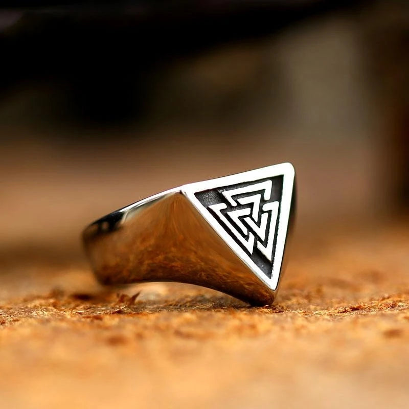 S925 silver Viking triangle signet ring displayed in a rustic setting on a dark wooden surface.