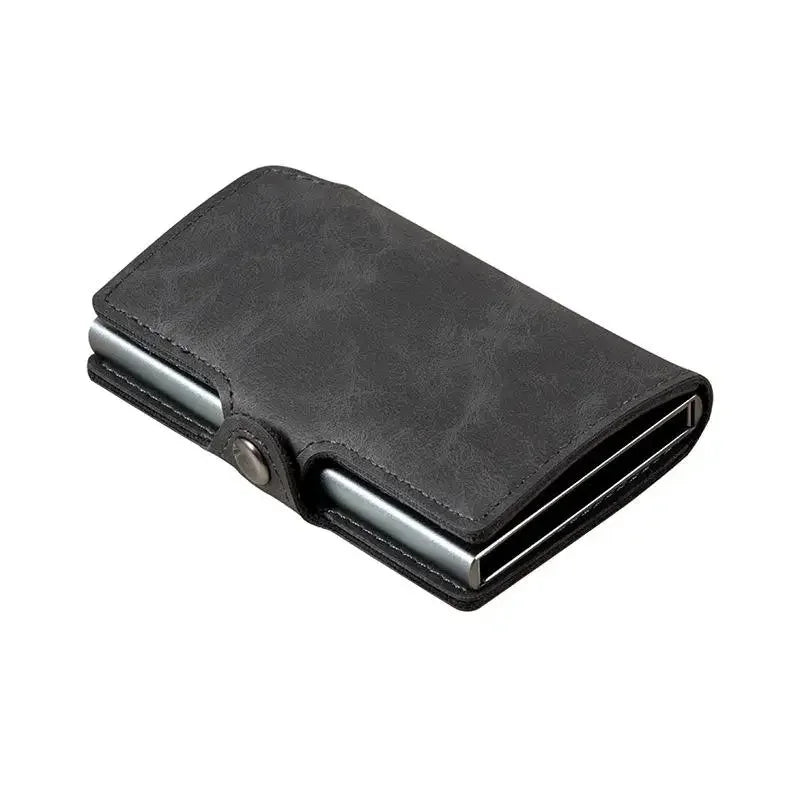 Slim RFID-blocking pop-up wallet in a matte charcoal grey leather finish with silver aluminum interior details