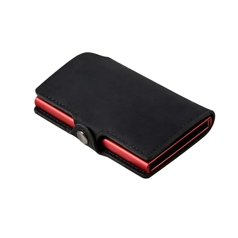 Mini smart card wallet featuring a black split leather exterior wrapped around a vibrant anodized red aluminum pop-up card block