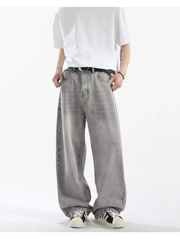 Minimalist streetwear outfit featuring light gray acid wash baggy straight-leg pants and clean white sneakers